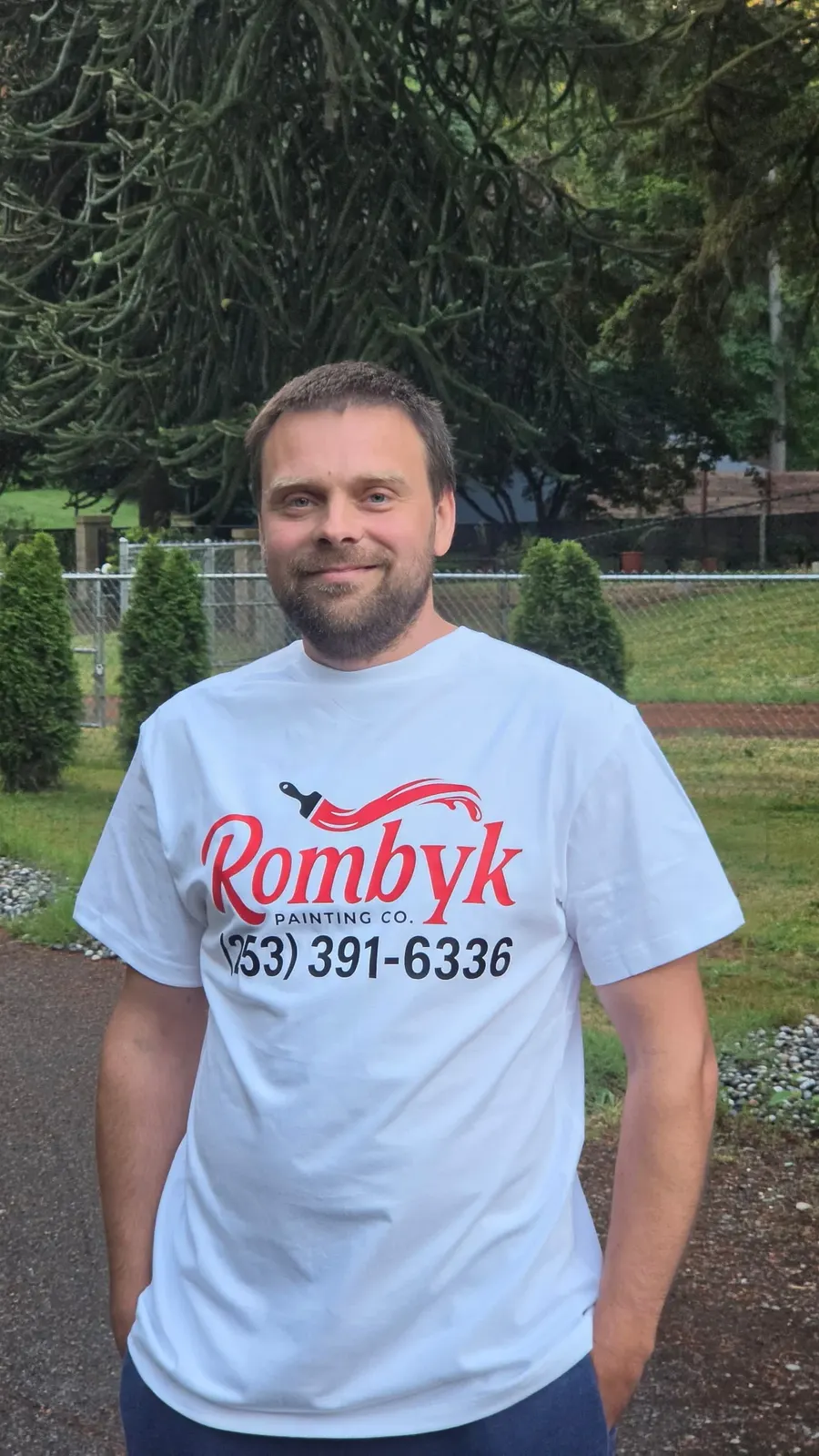 Rombyk Painting owner wearing a branded company shirt