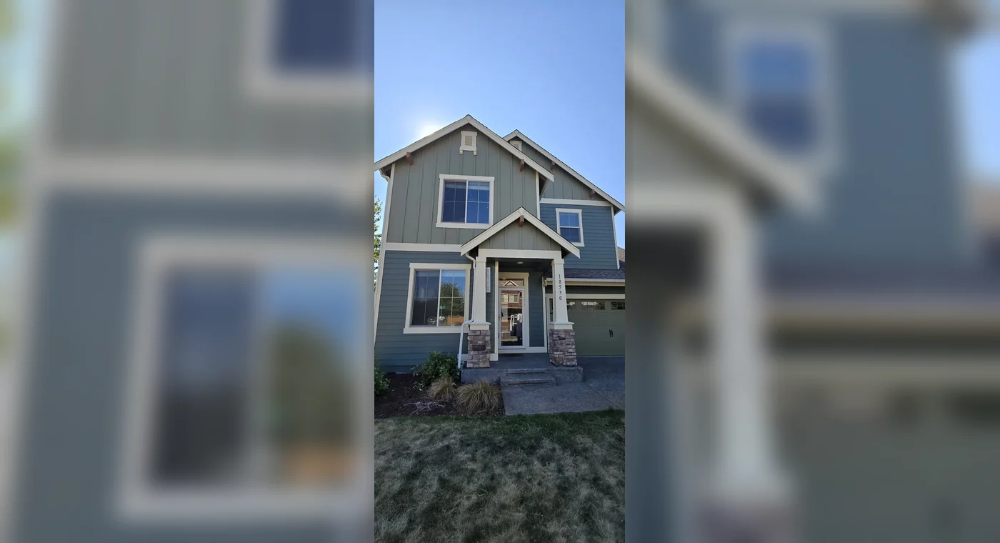 Finished exterior with gray siding and white trim